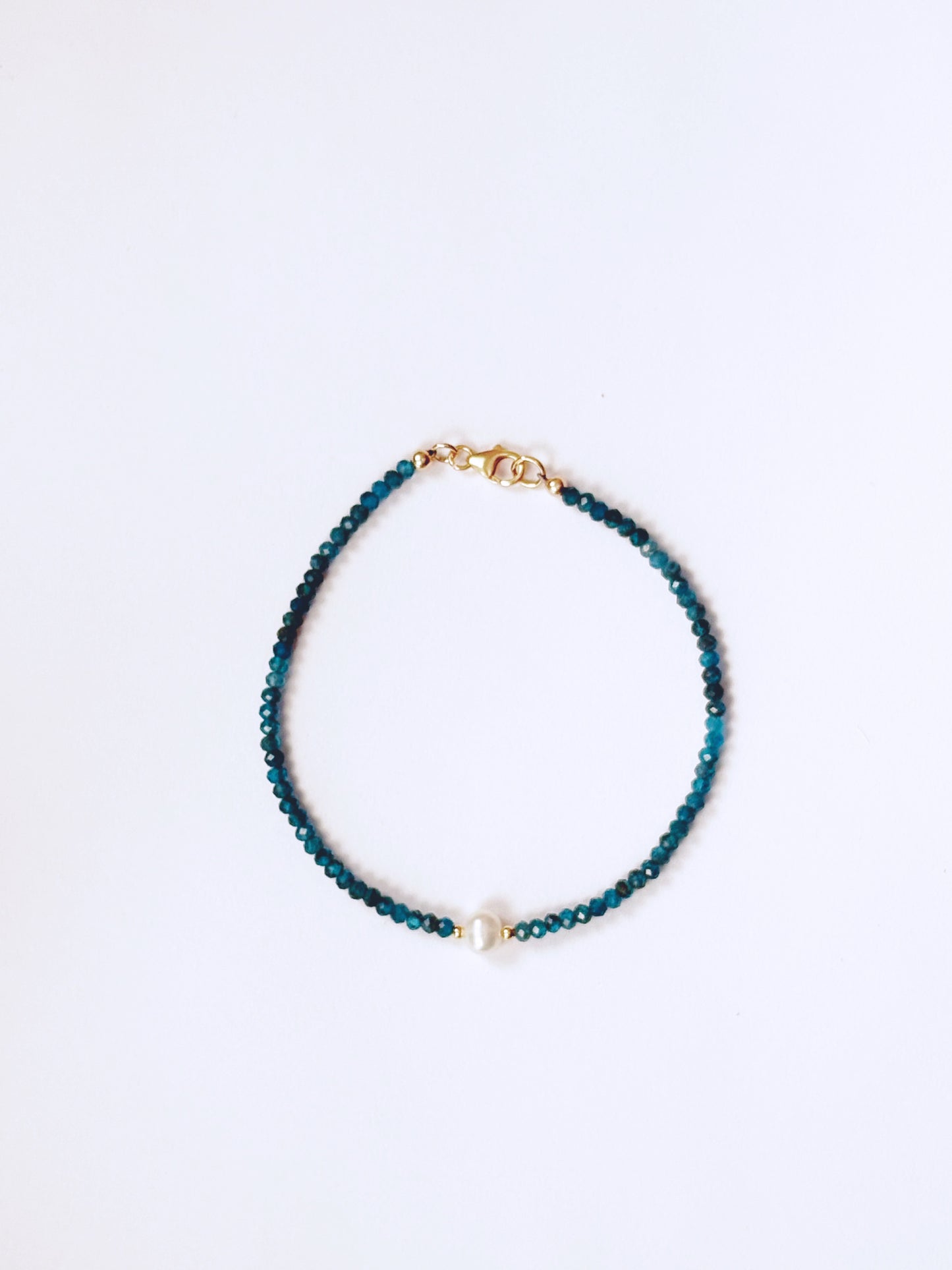 Blue beaded bracelet on a white background