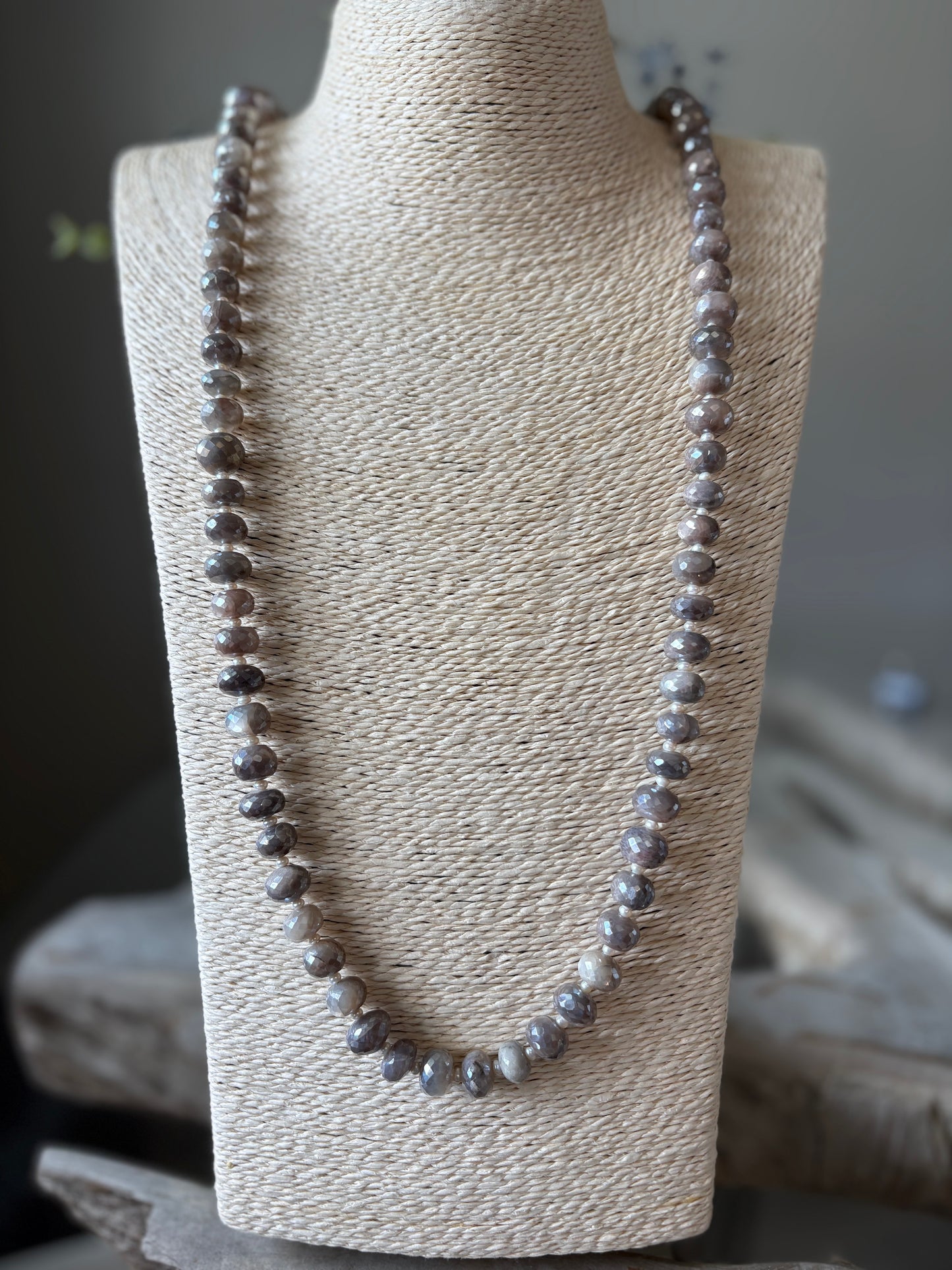 Chocolate Moonstone and Pearl Necklace displayed on a light-colored woven bust