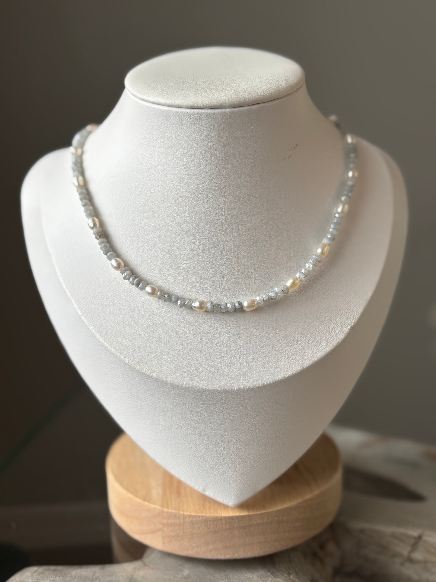 Aquamarine and Pearl Necklace on a white display stand