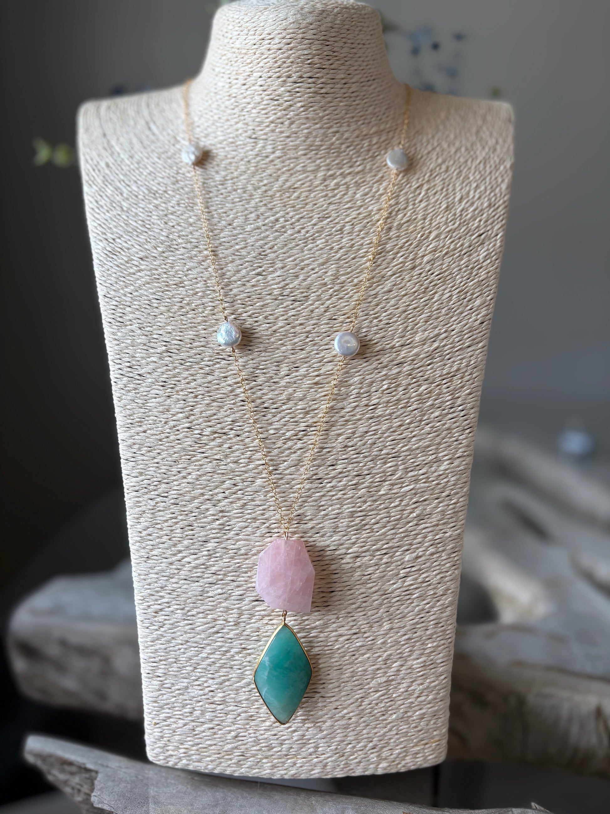 Rose Quartz and Amazonite Necklace with gold chain and pearl accents on a display bust