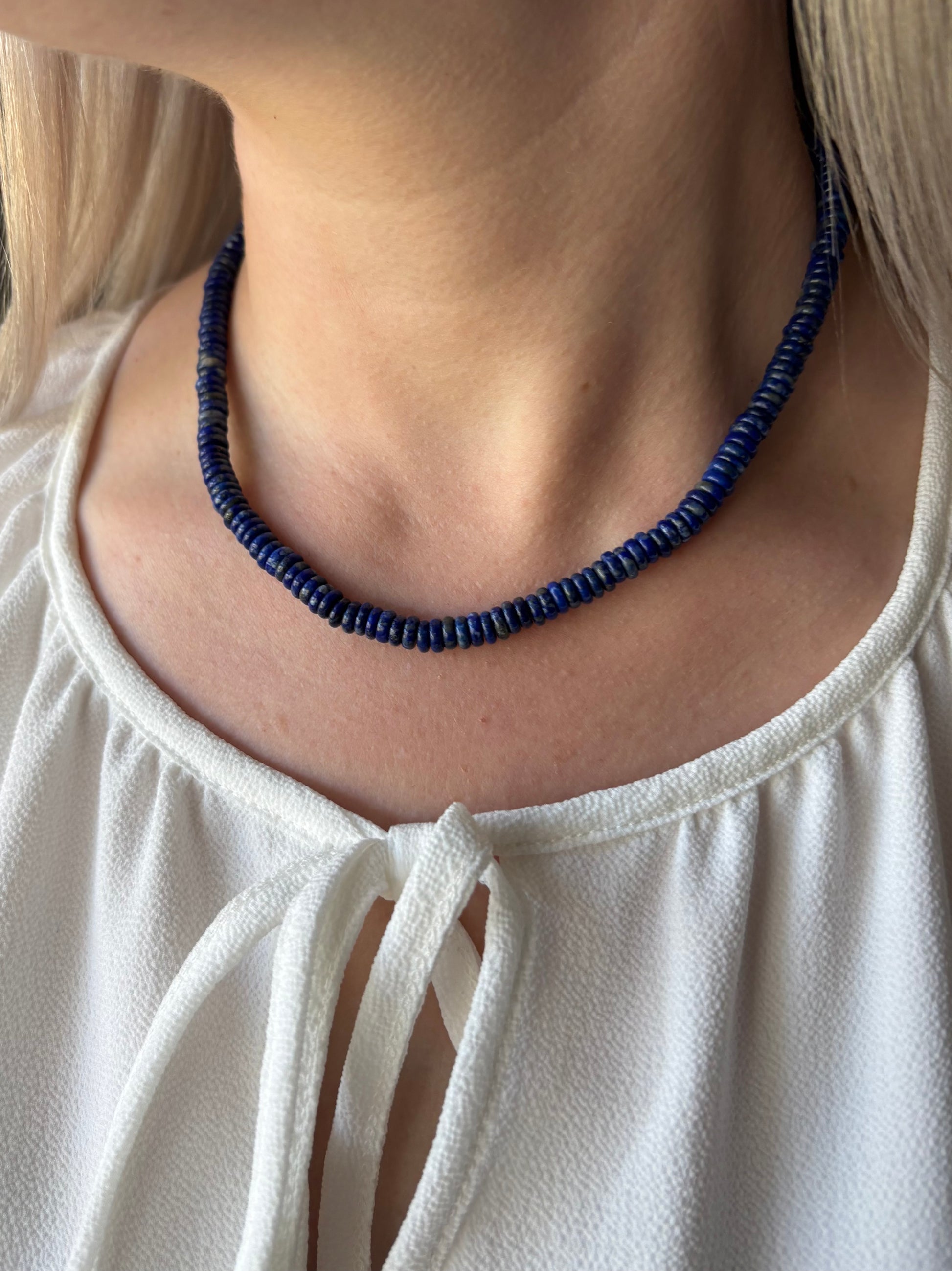 Lapis Necklace 14"-17" on a person's neck, wearing a white top