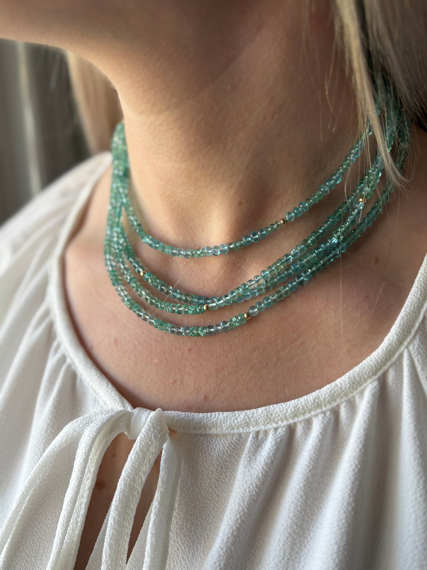 Long Aqua Apatite Necklace with multiple strands of small aqua beads and gold accents