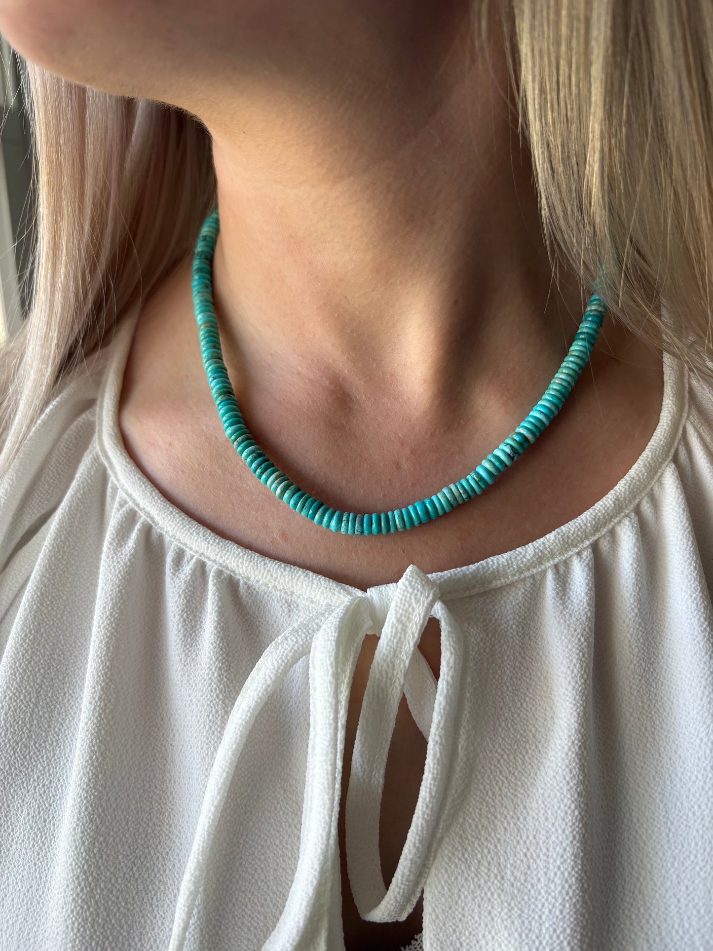 Turquoise Necklace on a person wearing a white top
