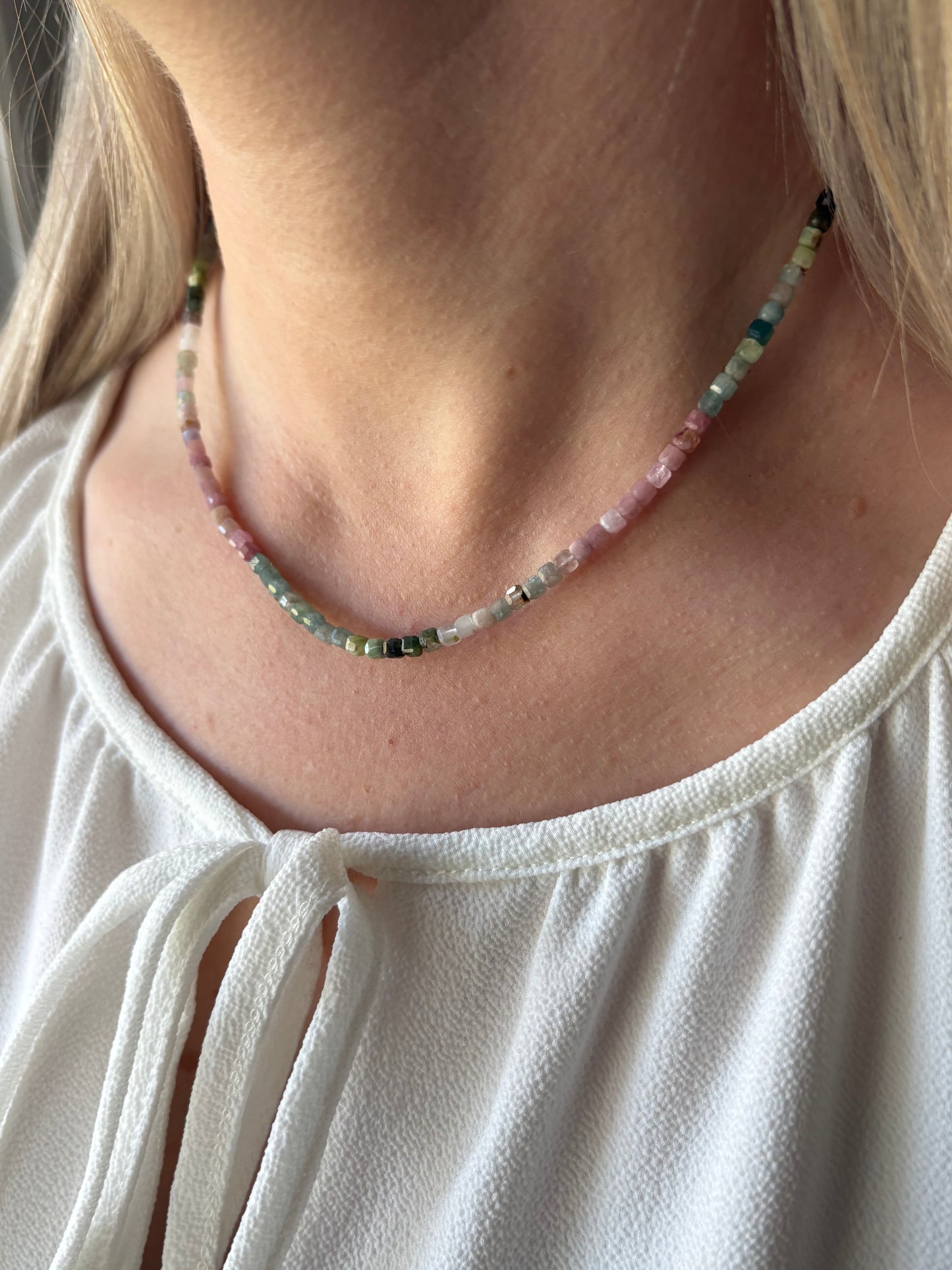 Tourmaline Cube Necklace with multi-colored cube beads on a person's neck