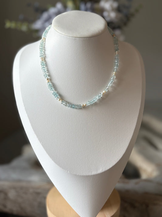 Necklace on a white bust with a blurred background