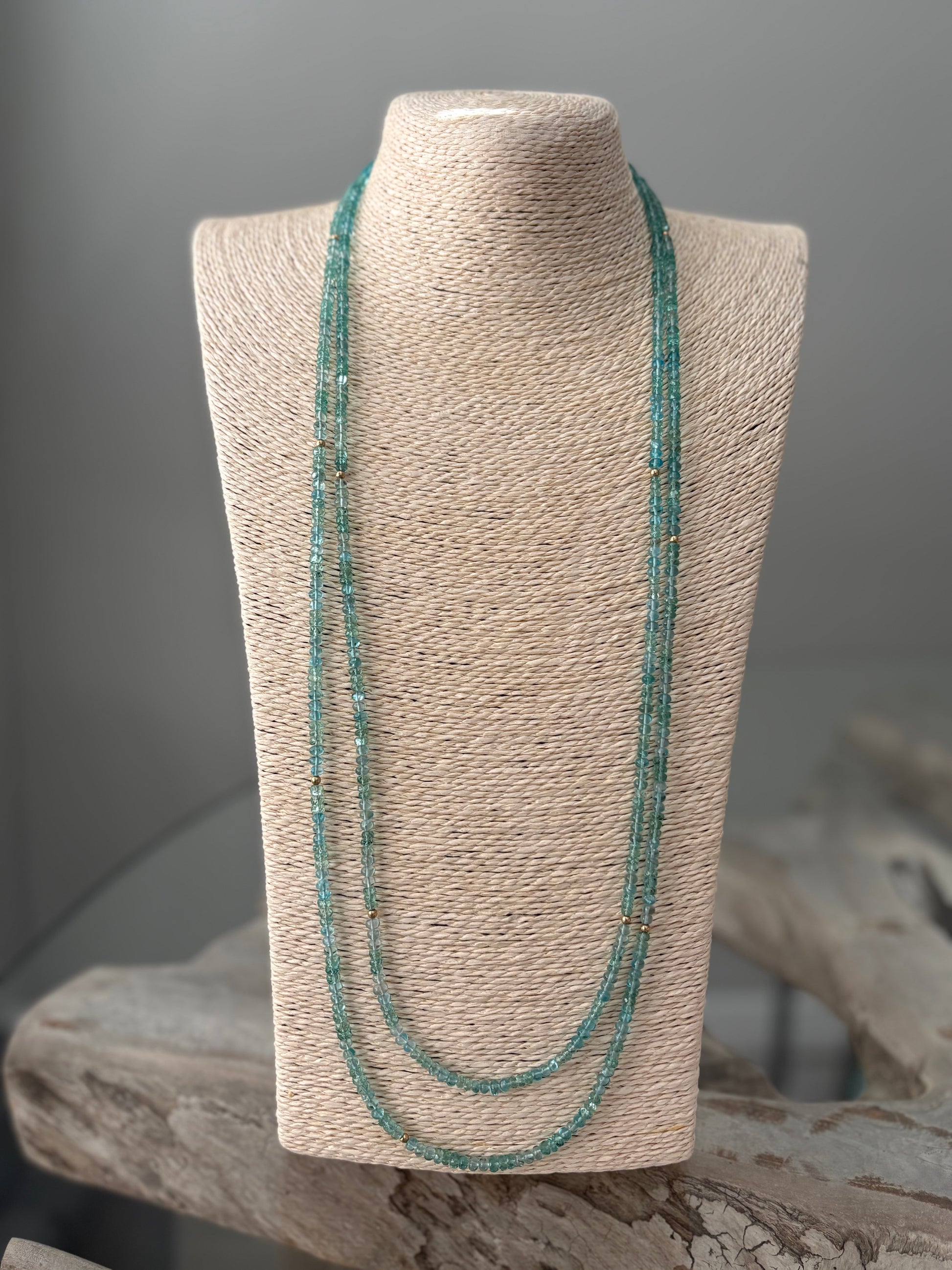 Necklace on a mannequin bust with a neutral background