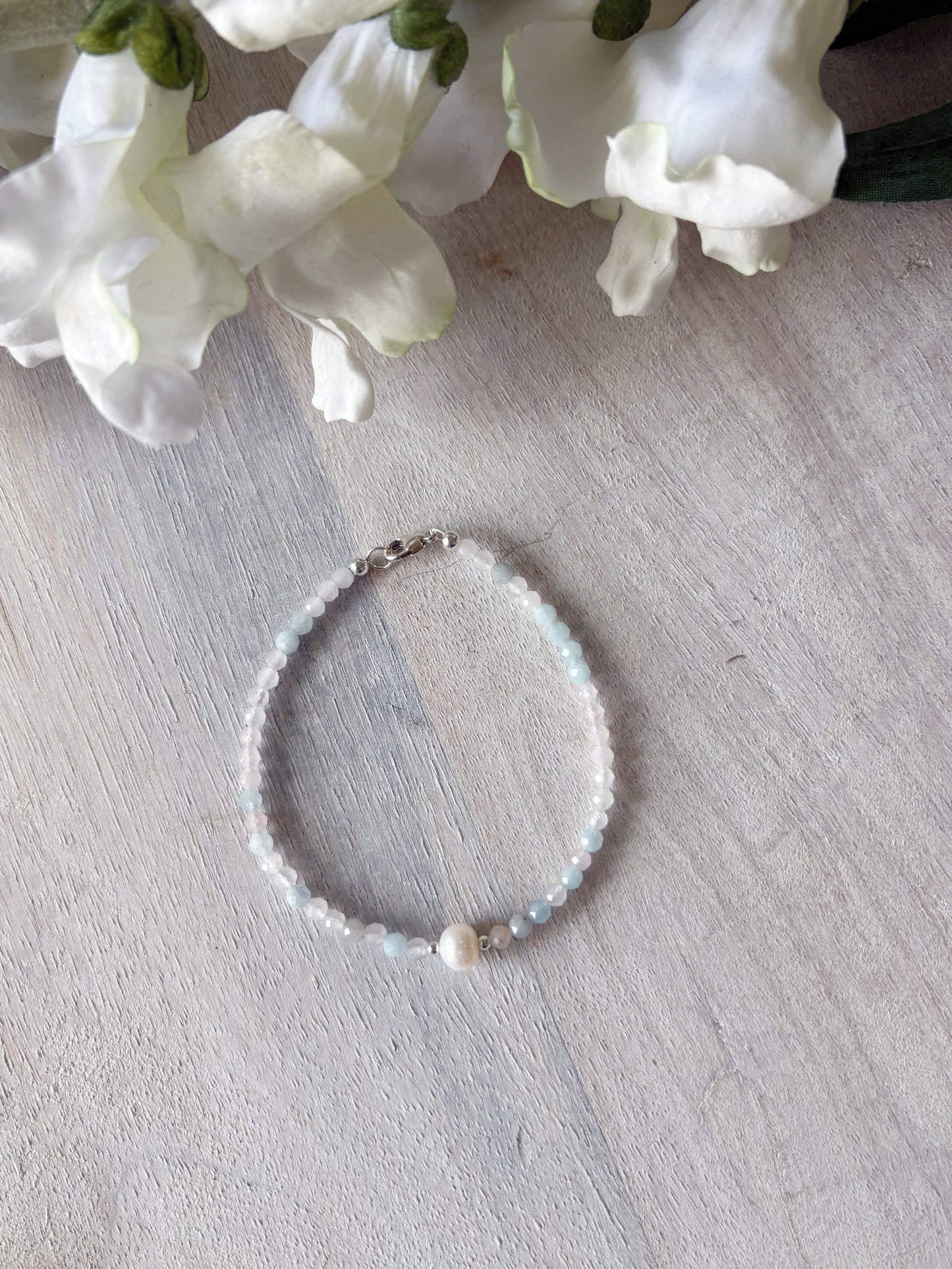 Morganite and Pearl Bracelet with light pink and blue beads, a single pearl, and a silver clasp