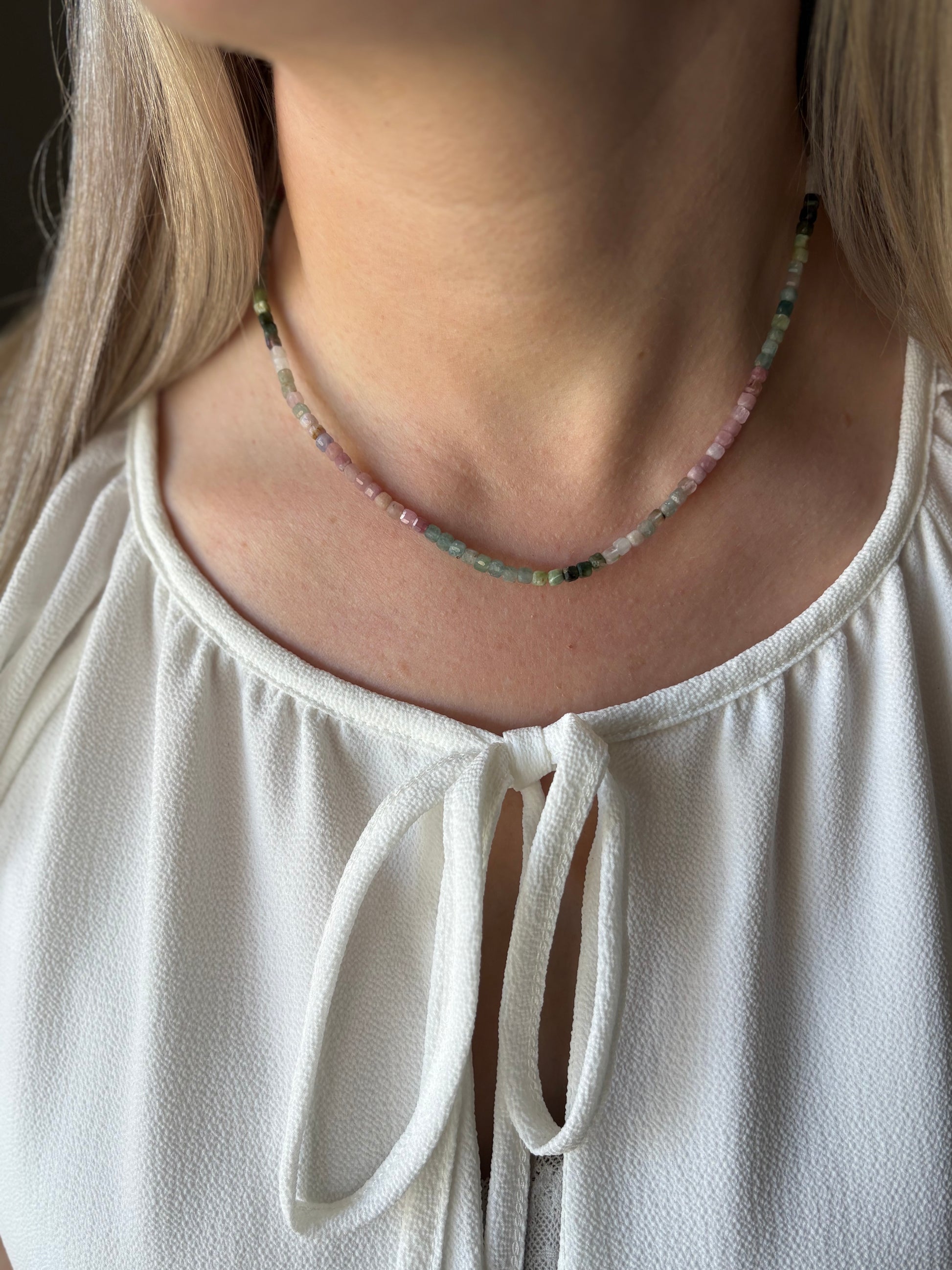 Tourmaline Cube Necklace on a woman wearing a white top