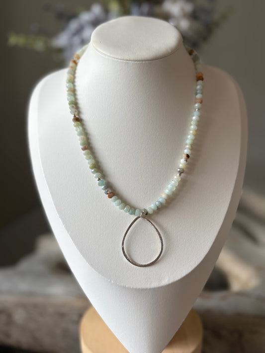 Necklace with a pendant on a white mannequin bust