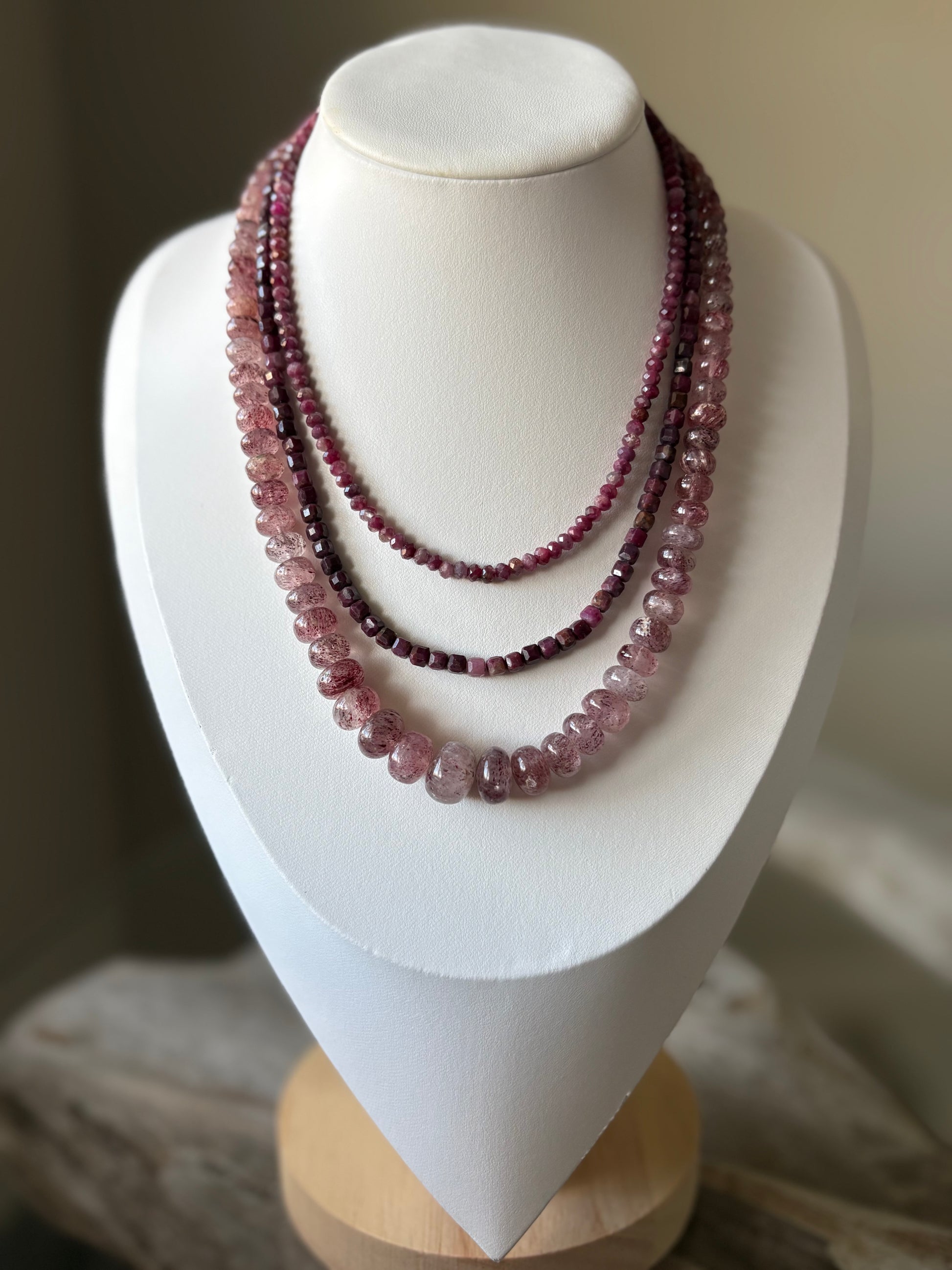 Red Tourmaline Necklace on a white display stand