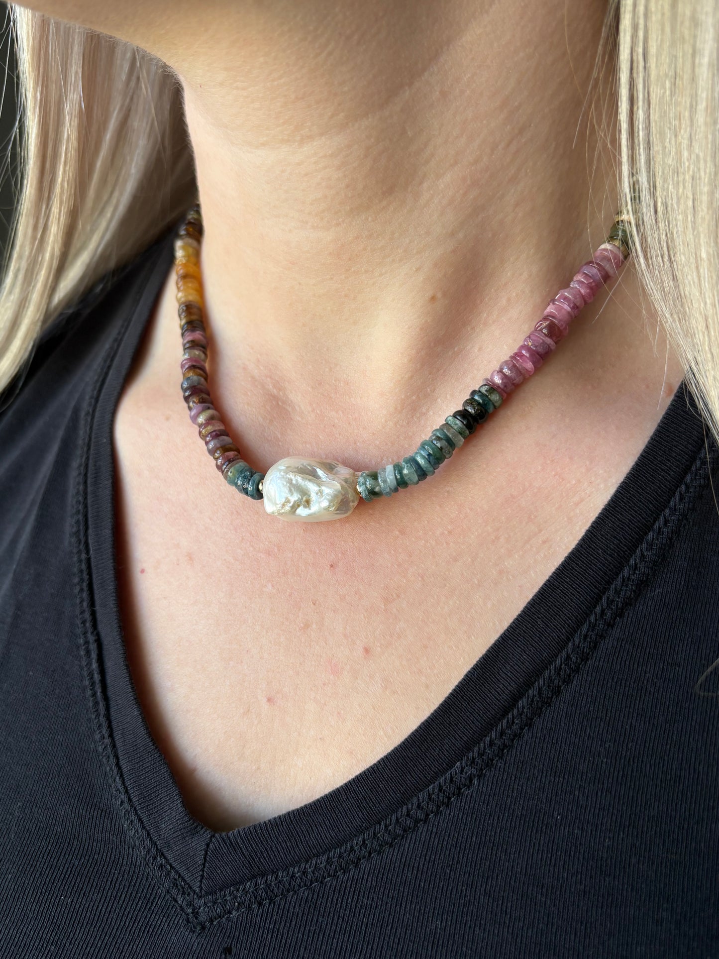 Tourmaline and Pearl Necklace on a person's neck