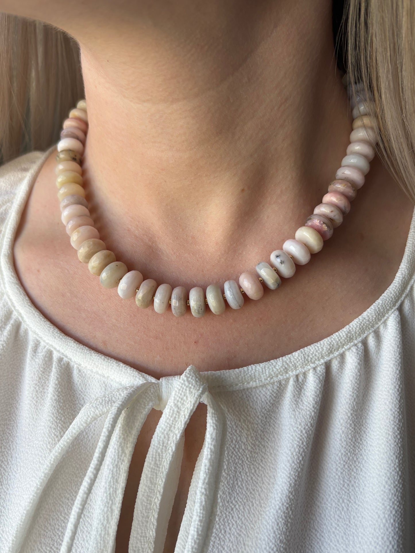 Chunky Pink Opal Necklace on a person's neck, wearing a white top