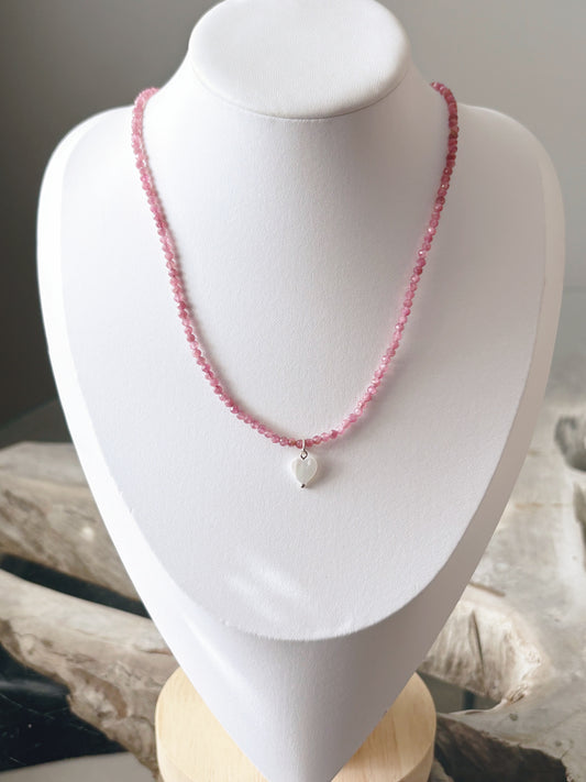 Pink Tourmaline and Heart Necklace on a white display stand