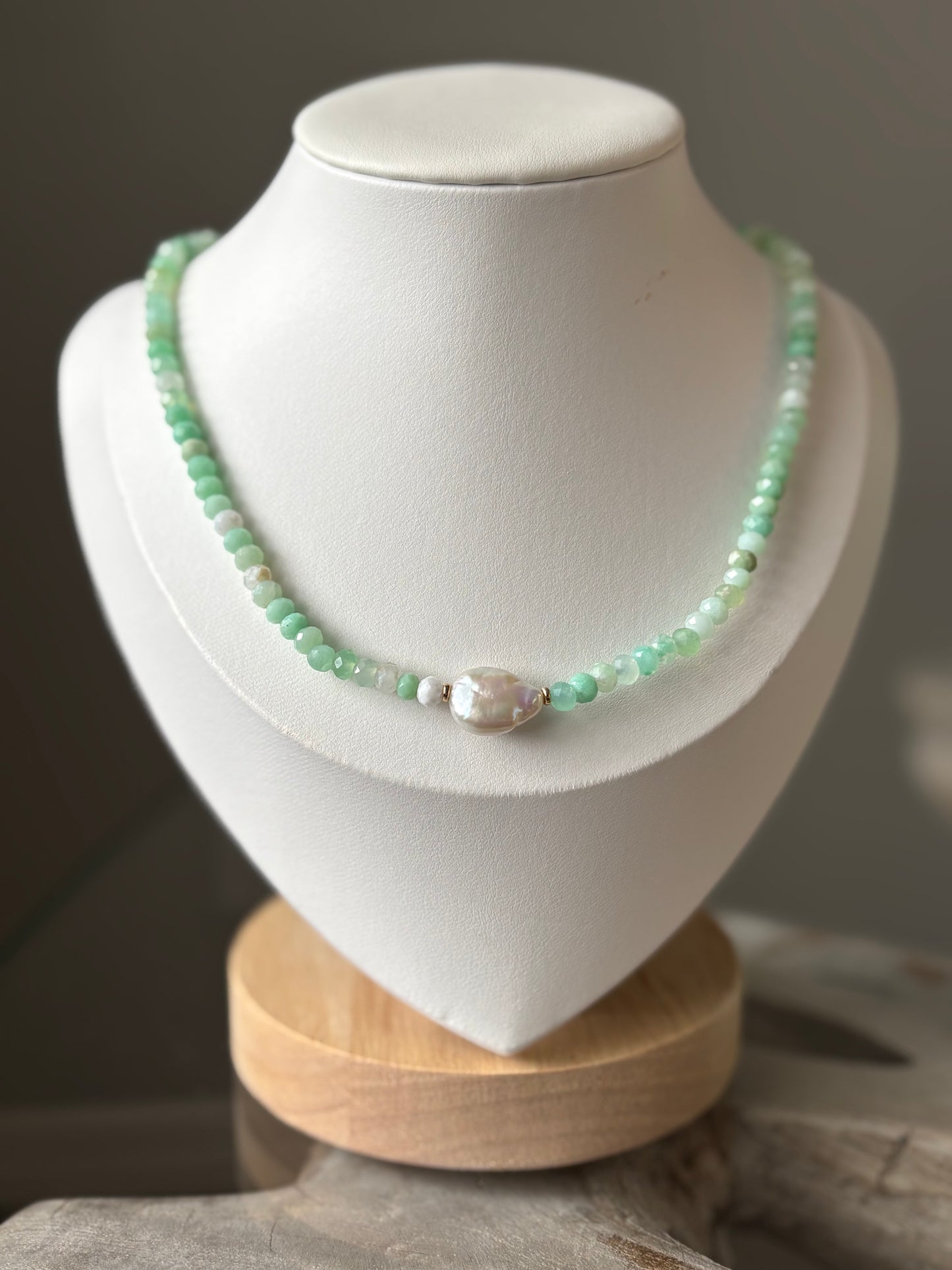 Green gemstones and pearl necklace